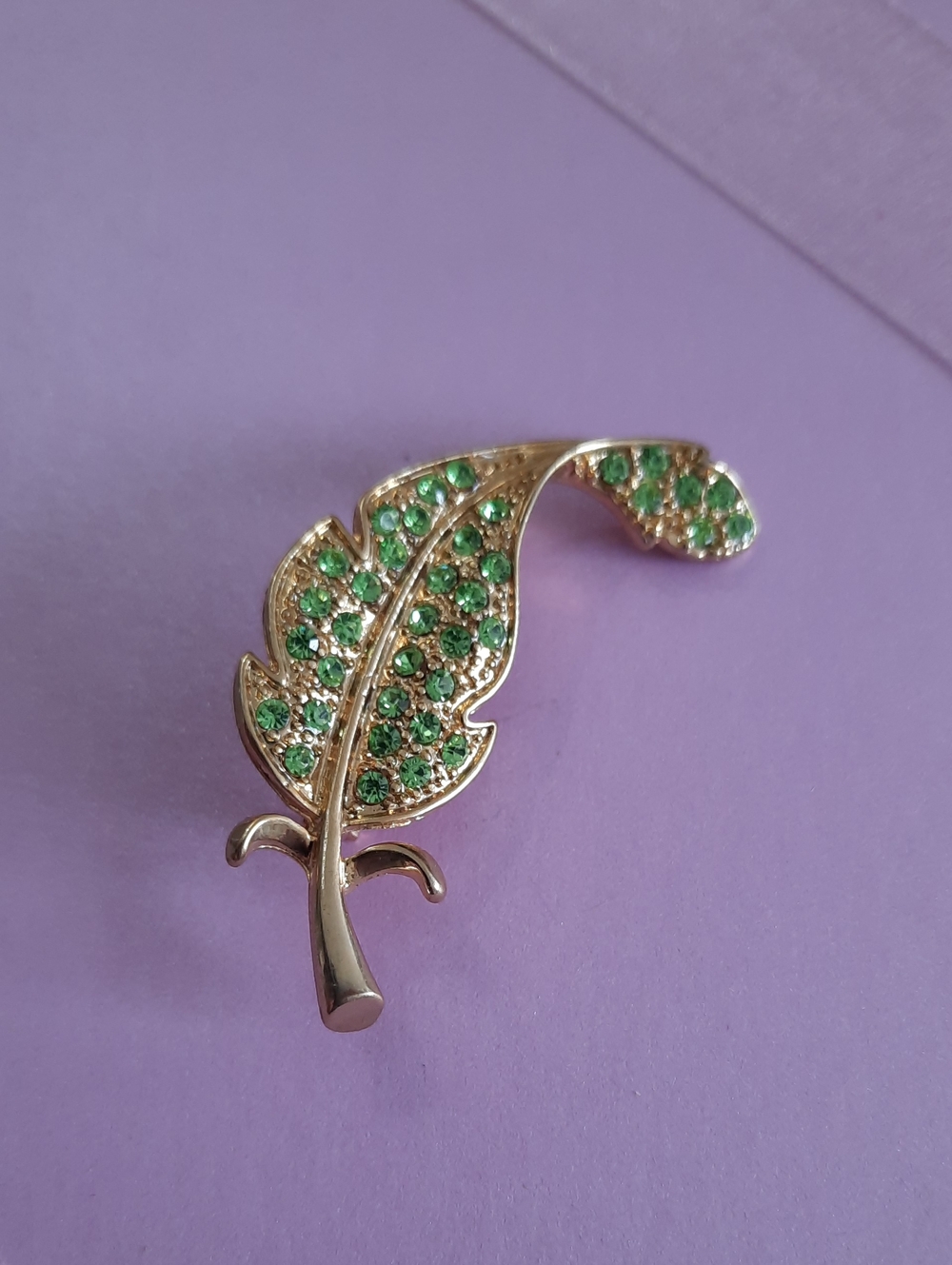 Gold-tone Feather Brooch with Green Crystals